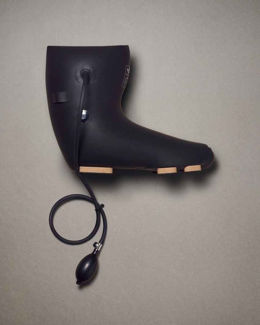 A black Adidas boot by Craig Green