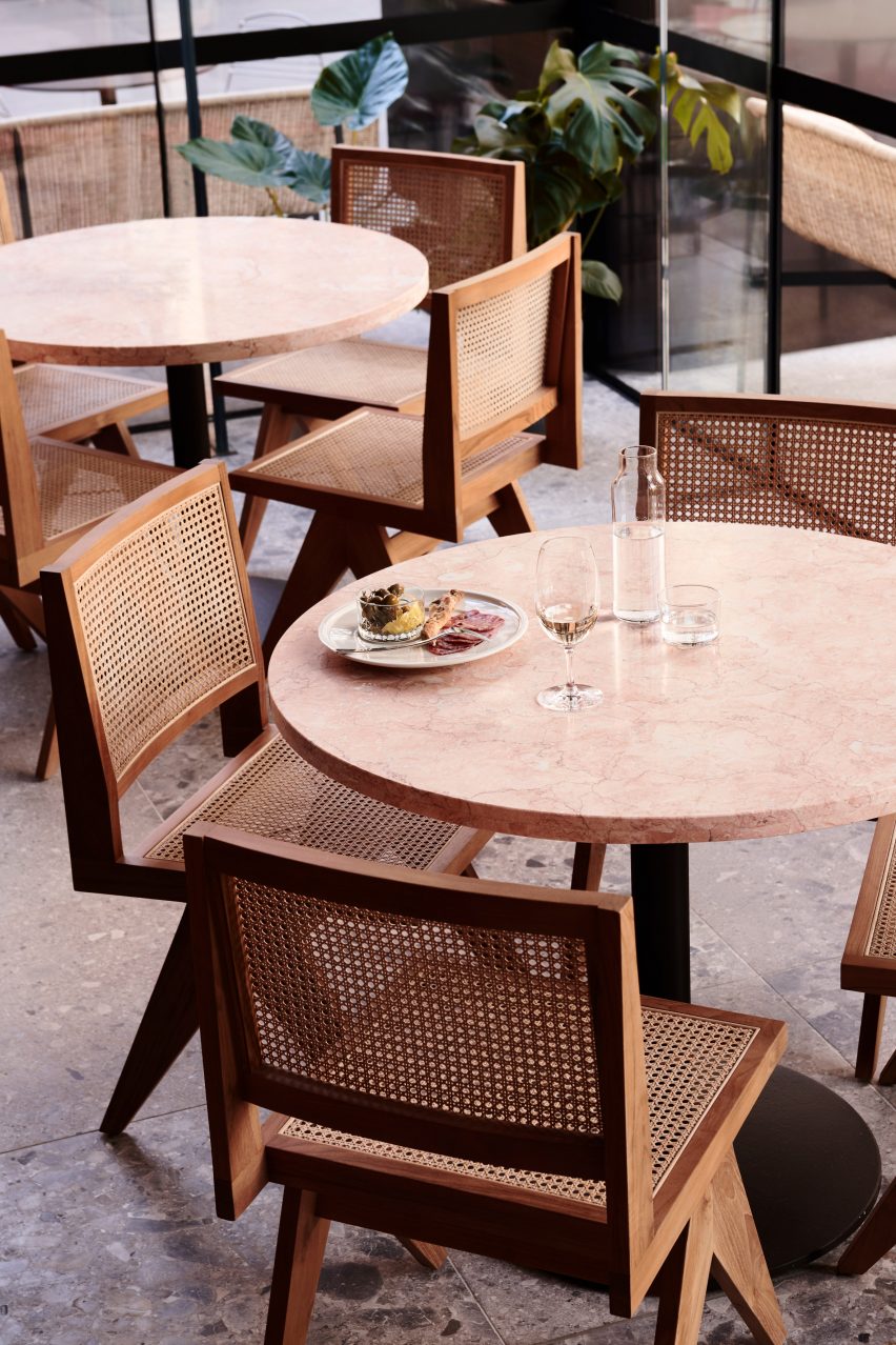Marble tables and wicker-backed chairs