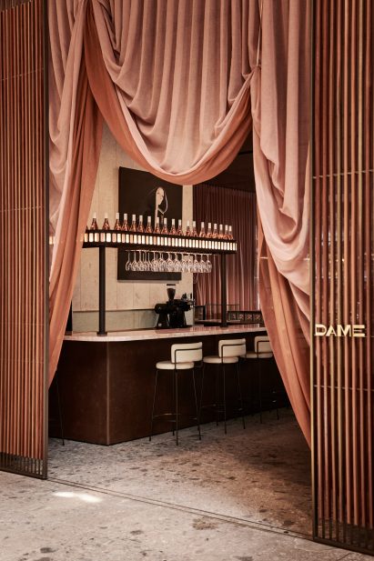 Dame entrance through draped curtain