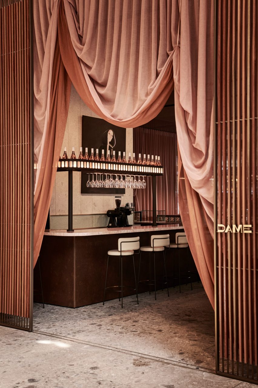 Dame entrance through draped curtain