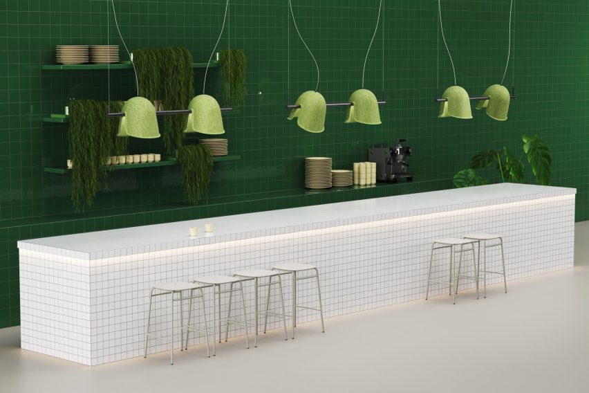 Green lamps haning above a white island counter
