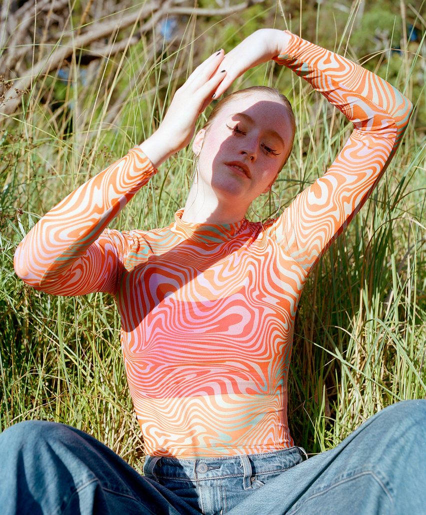 Person is pictured wearing The Binder under a mesh top