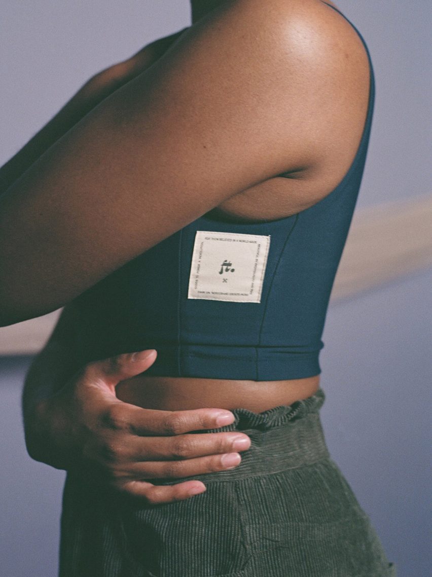 Person seen from the side wearing The Binder for chest compression, giving the appearance of a more flat chest