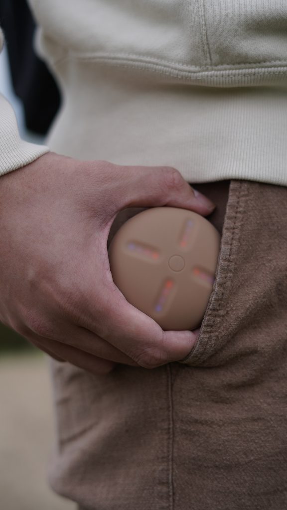 A man putting a Stem Player into his pocket
