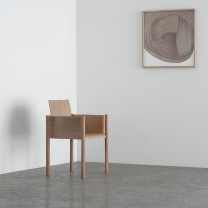 The chair is pictured beside a painting