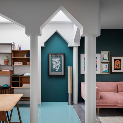 Study inside La Serenissima house by Valentino Architects with petrol green walls and pointed archways
