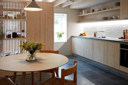 Kitchen with stone flooring and wooden cabinets
