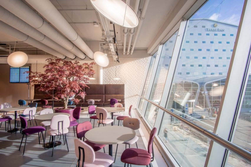 Pink Maarten Baas chairs in a cafe populated around tables