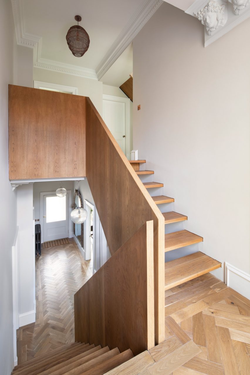 A curving staircase connecting a house to its extension