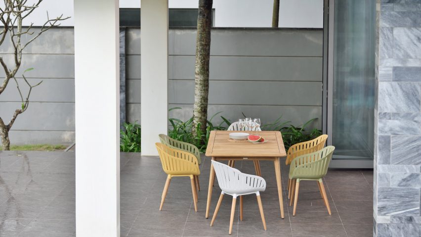 Multicoloured chairs from Nassau furniture collection by LifestyleGarden surrounding a wooden table