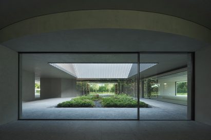 Glazed walls surround an internal garden