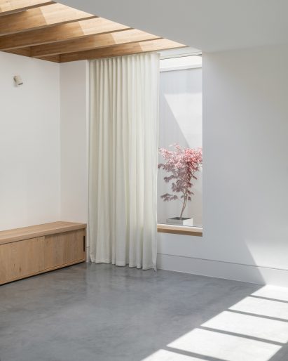 Interior image of a living space with light filtering through a skylight 