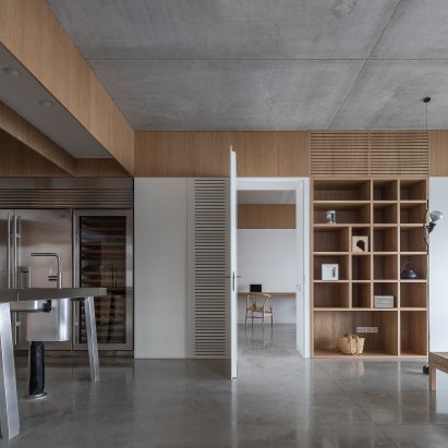 Open plan kitchen and dining room with wooden shelves