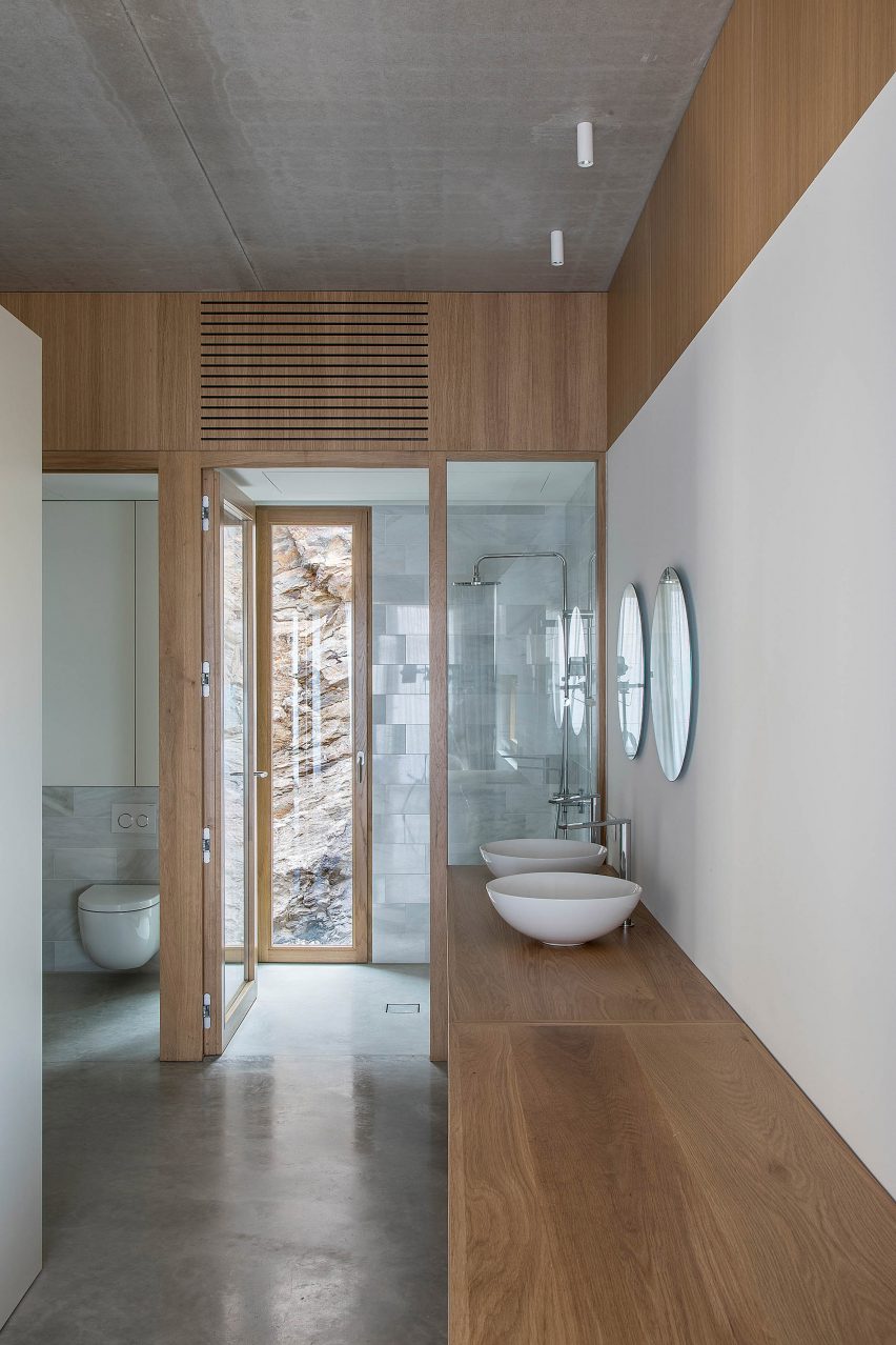 White bathroom with wooden cabinets