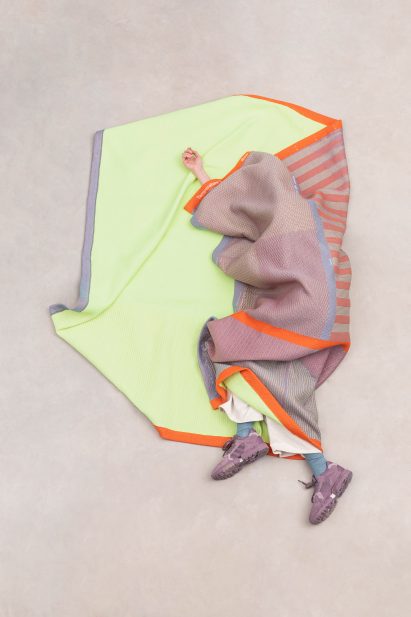 Person wrapped up in Raw Color's Temperature Textiles blanket