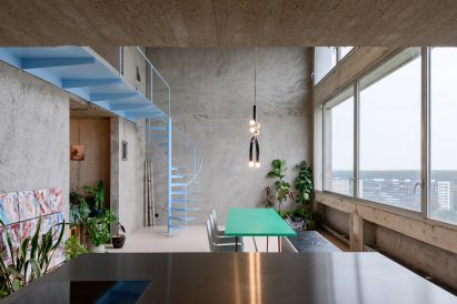 Turquoise table in room with concrete walls