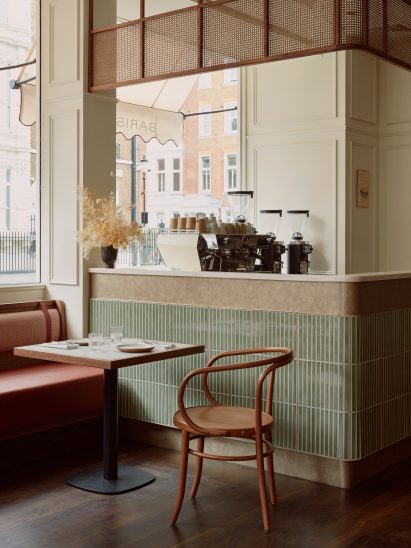 A vintage restaurant interior with green tiles and red seats