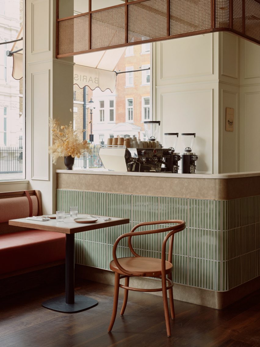 A vintage restaurant interior with green tiles and red seats