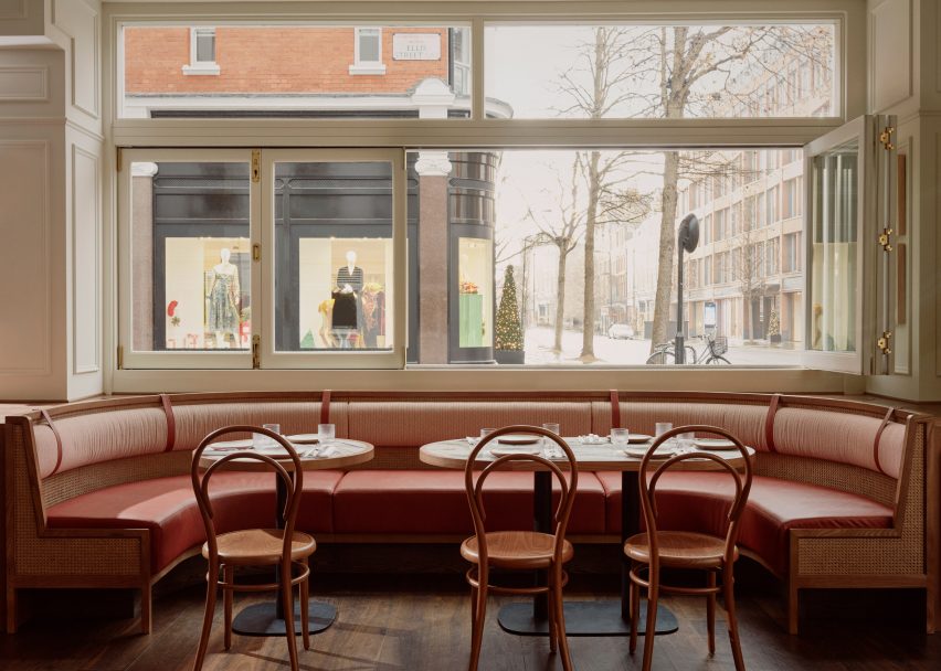Dining tables and chairs in front of a window