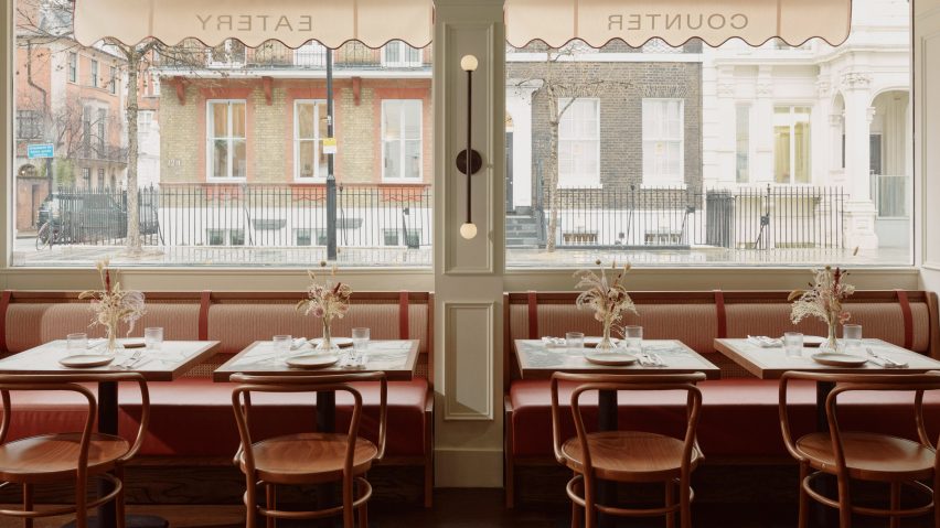 Dining tables and chairs in front of a restaurant window
