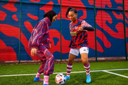 Two women playing football in Stella McCartney for Adidas kits