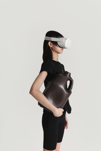 A woman holding a bag shaped like a milk carton
