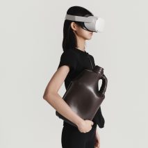 A woman holding a dark purple bag
