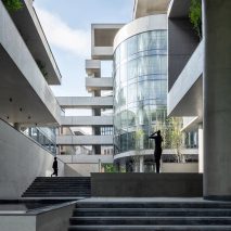 A glass rotunda is located beside an external staircase