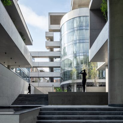 A glass rotunda is located beside an external staircase