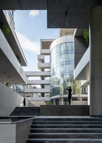 Image of a sunken courtyard that looks across to a glass cylindrical building