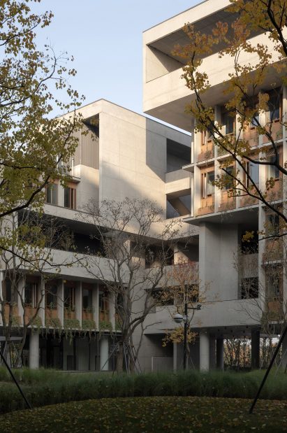 Green courtyard surrounded by the concrete Luxelakes Floating Headquarters