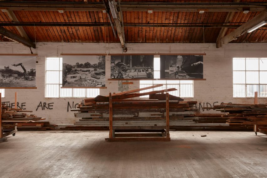 Work room in the Revival Projects' hub with stacks of material and large-scale photographs of building sites on the walls