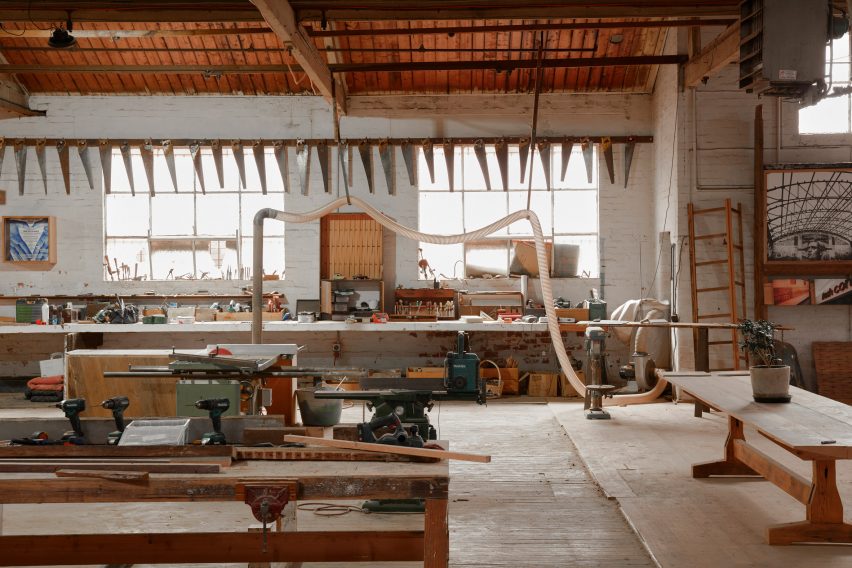 Work space in the Zero Footprint Repurposing hub with benches covered with tools