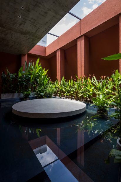 A shallow pool with circular platform was positioned beneath a skylight