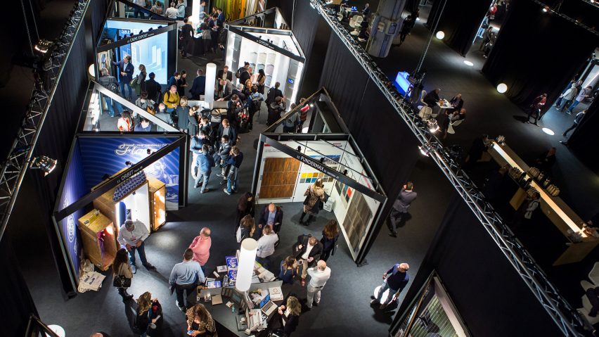 A photograph of people looking at the architect@work displays