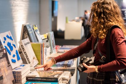 A woman looking at the RIBA books on display