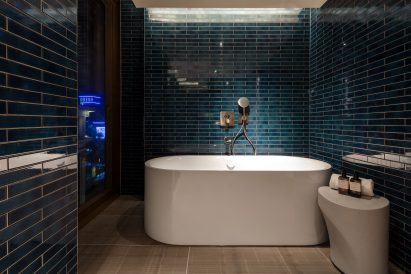 A photograph of a blue bathroom in The Londoner