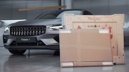 A photograph of artwork balanced on a Polestar car