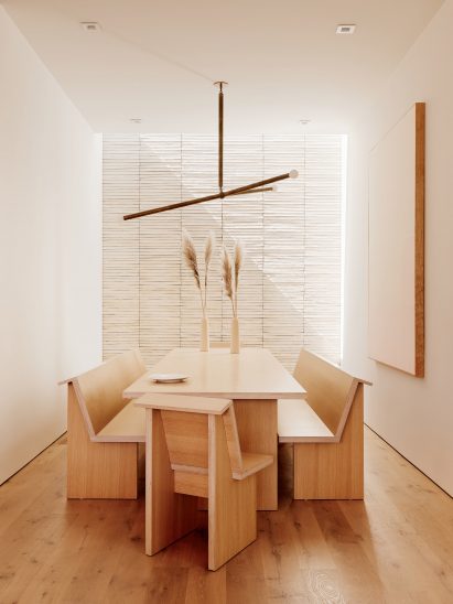 dining room with brick wall and brown furntiure