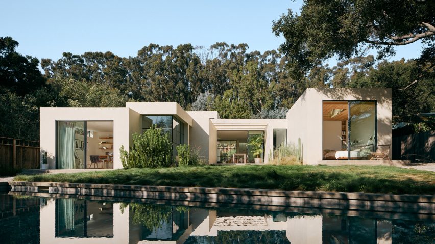 stucco home reflected in backyard pool
