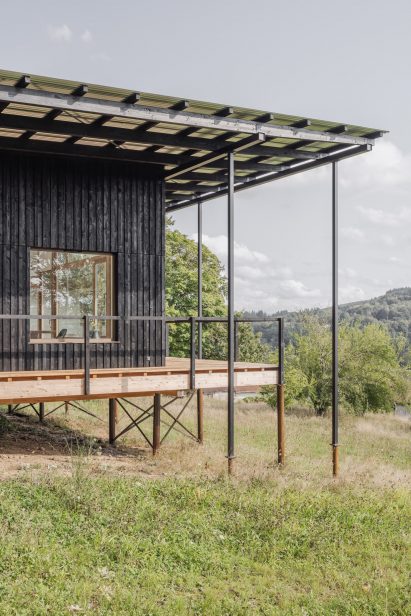 Image of the wooden house from the side revealing its structural support