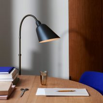 Stone grey Bellevue lamp next to a wooden desk