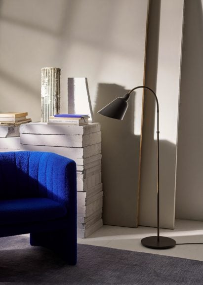 Stone grey Bellevue lamp next to a blue chair