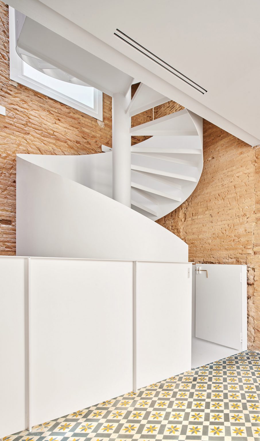 Spiral staircase features inside BSP20 House by Raúl Sánchez Architects