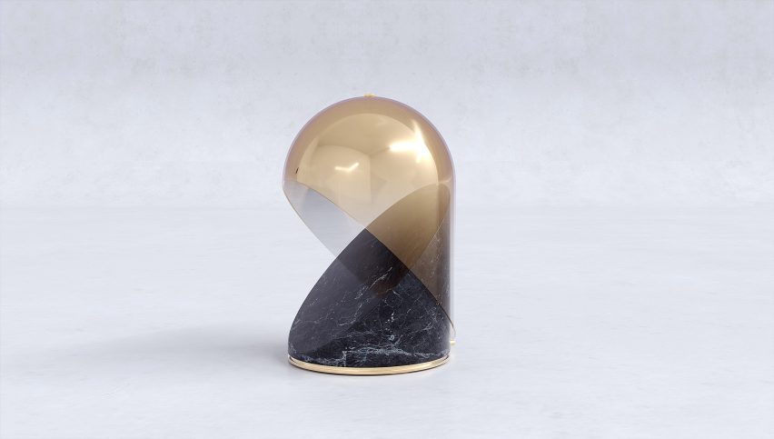 Gold and black Cassiopea table lamp with a white background