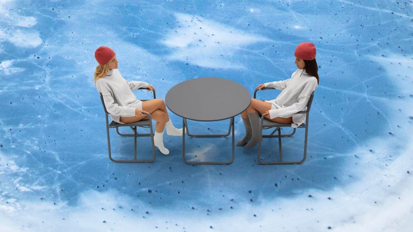 A photograph of two people sitting on Trip chairs in grey