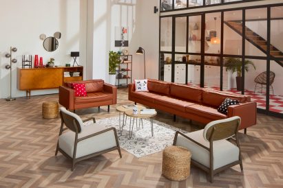 Living room filled with Disney Home accessories including Mickey Mouse pillows and mirrors