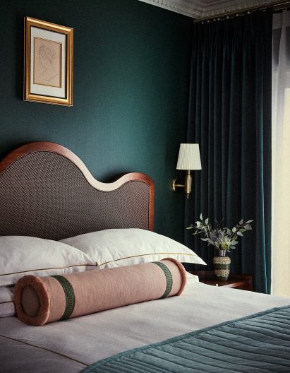 A bedroom with green walls inside Esme Hotel