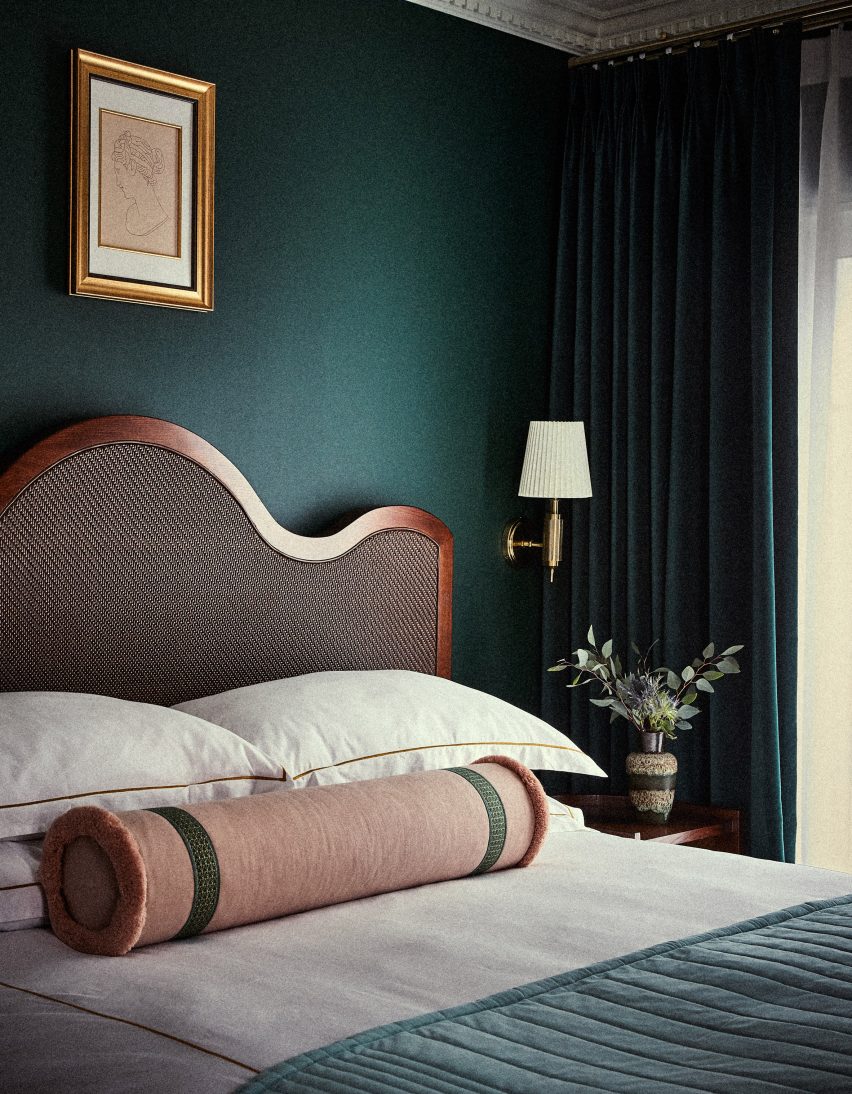 A bedroom with green walls inside Esme Hotel