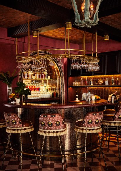 A round bar at Esme Hotel with stools around it